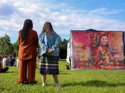 People on grass watching live music 