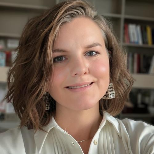 Photo of Dr. Lindsay Larios standing in front of a bookshelf